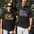 Male and Female wearing black short sleeve t shirts with graphic design with NAIDOC Theme For Our Elders with footprints