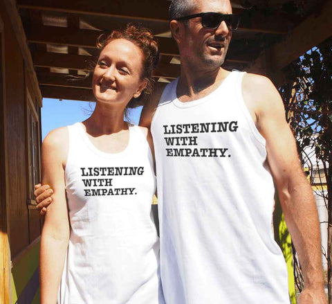 White Singlet T Shirt. Graphic is stacked words in black. The text reads Listening with Empathy.