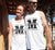 Male and Female outside a house wearing white singlet tank T Shirts. Graphic large letter M. The text reads Metacognition, think about your thinking.