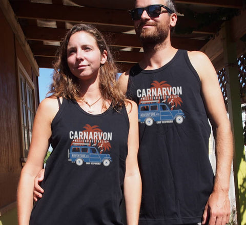 Male and Female outside a house wearing Black Singlet T Shirts.  Graphic of a Troop Carrier vehicle with Palm Trees.  Text reads Carnarvon, Western Australia Camp Responsibly.