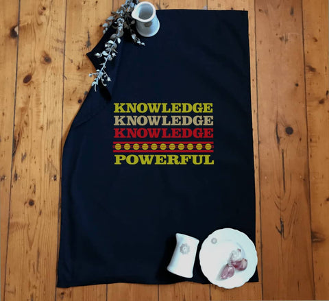 Yellow Tea Towel.  Graphic is stacked words in shades of yellow and red.  The text reads Knowledge, repeated 3 times, and Powerful.