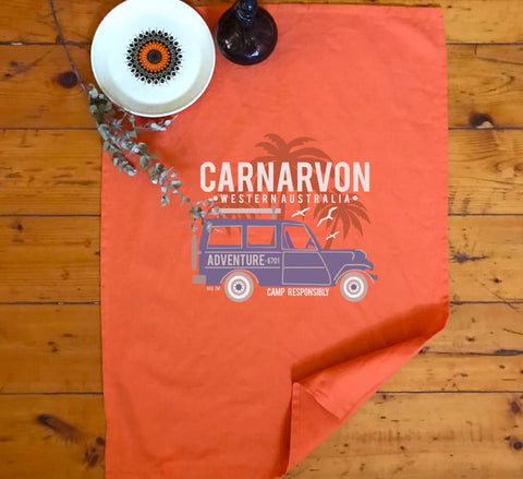 Orange Tea Towel in a kitchen.  Graphic of a Troop Carrier vehicle with Palm Trees.  Text reads Carnarvon, Western Australia Camp Responsibly.