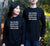 Male and Female in a garden wearing black long Sleeve T Shirts.  Graphic in white.  Think Flexibly repeated in 4 lines written in all directions..