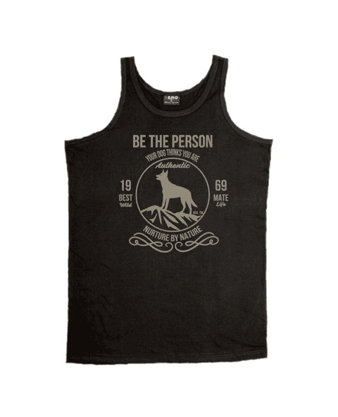 Black Singlet T Shirt with design. The graphic is in pale khaki colour.  There is a circle outline with a silhouette of a dog standing on a rocky outcrop.  Around the circle the text says - Be the person your dog thinks you are, Nurture by Nature.  On either side of the circle there is text that is split - it says 19-69, Best Mate, Wild Life