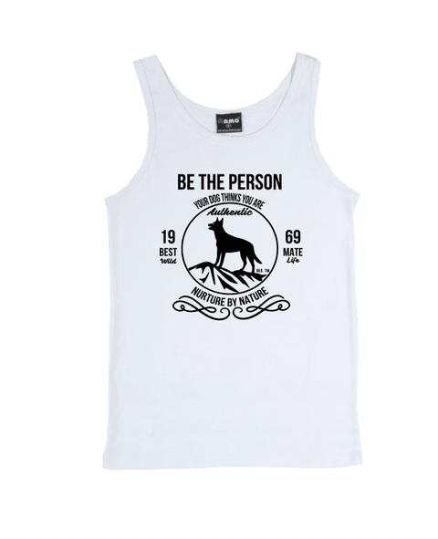 White Singlet T Shirt with design. The graphic is in pale khaki colour.  There is a circle outline with a silhouette of a dog standing on a rocky outcrop.  Around the circle the text says - Be the person your dog thinks you are, Nurture by Nature.  On either side of the circle there is text that is split - it says 19-69, Best Mate, Wild Life