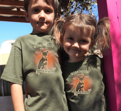 Boy and girl wearing kids khaki Short Sleeve T Shirt. Graphic of a dog with text reading Working Dog. Wild Life. Best Mate. Nurture by Nature.