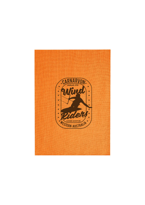 Orange Tea Towel.  Design is in black.  The graphics are of a silhouette of a kite surfer with the text Wind Riders, Carnarvon Western Australia,