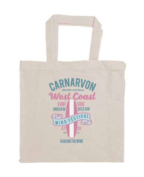 Shopper style calico bag. Design in blue and pink. Surfboard with banner saying Wind Festival. Text reads Carnarvon Western Australia. West Coast. Surf Side. Indian Ocean. 6701. Chasing the wind.