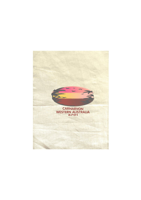 Natural Colour Tea Towel. Text in red Carnarvon, Westerm Australia. Graphic of palm trees and birds in silhouette against a sunset.