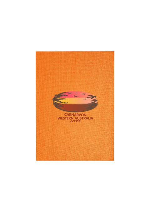 Orange Tea Towel. Text in red Carnarvon, Westerm Australia. Graphic of palm trees and birds in silhouette against a sunset.